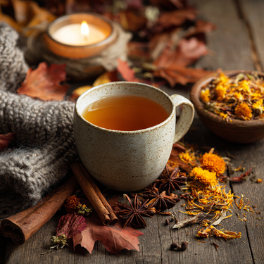 Pumpkin Creme Chai on wooden table with spices and tea a candle in background